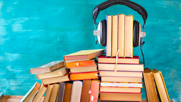 Stacks of books with headphones on top.