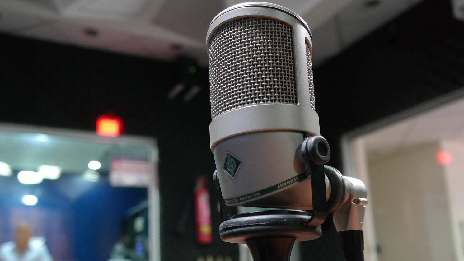 Image of a microphone placed in a recording studio.