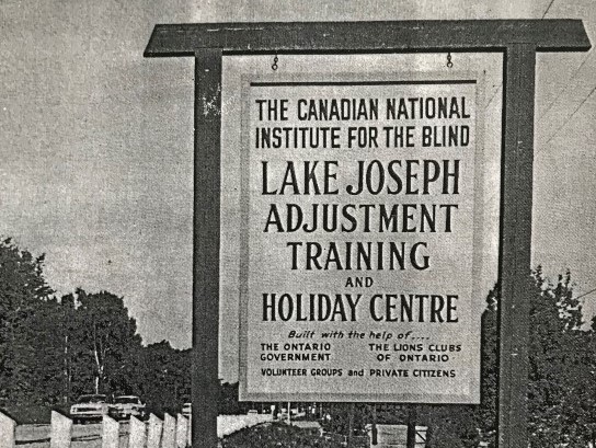 Black and white photo of the entrance sign to the Canadian National Institute for the Blind Lake Joseph Adjustment Training and Holiday Centre, 1965