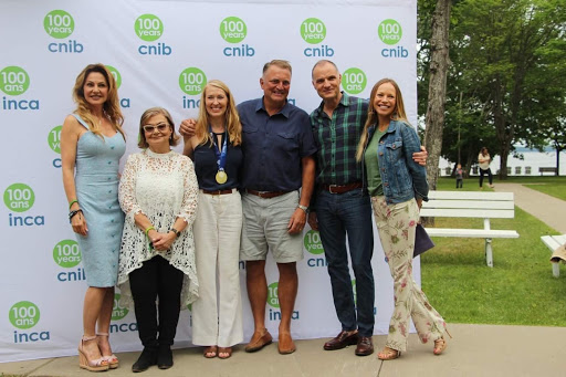 Joan Kelly-Walker, Eyre Purkin-Bien, Nancy & Steve Simonot, Tim Hogarth and Lesley MacAulay pose for a photo with the CNIB branded step & repeat in the background. 