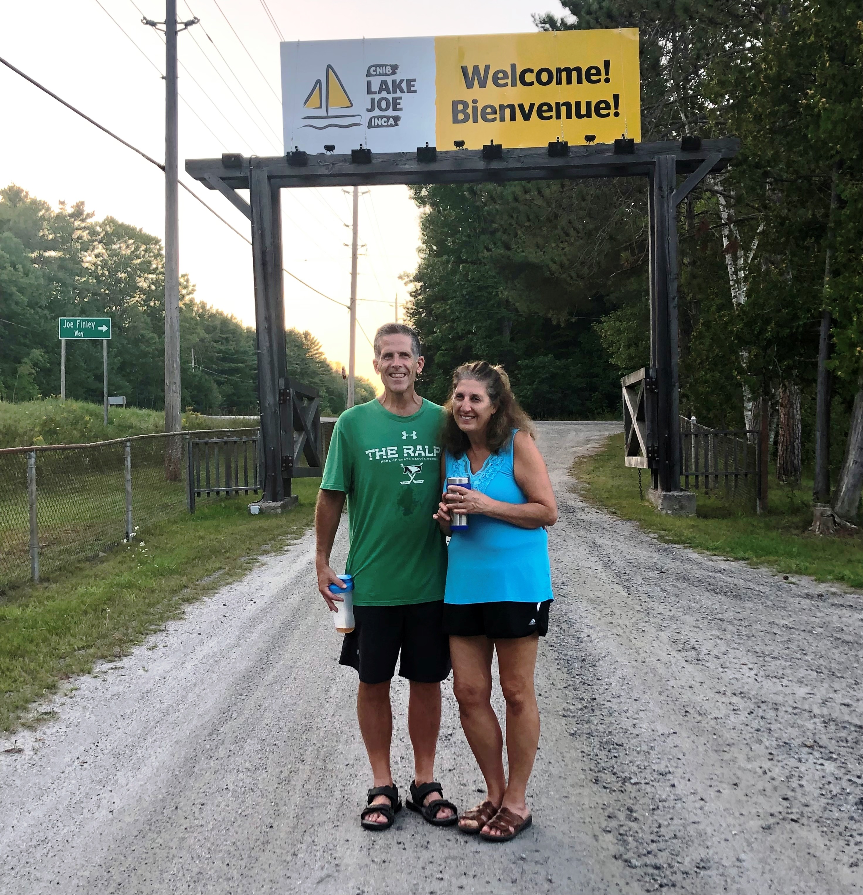 Miriam and Matt Hesselbart standing infront of the Lake Joe entrance