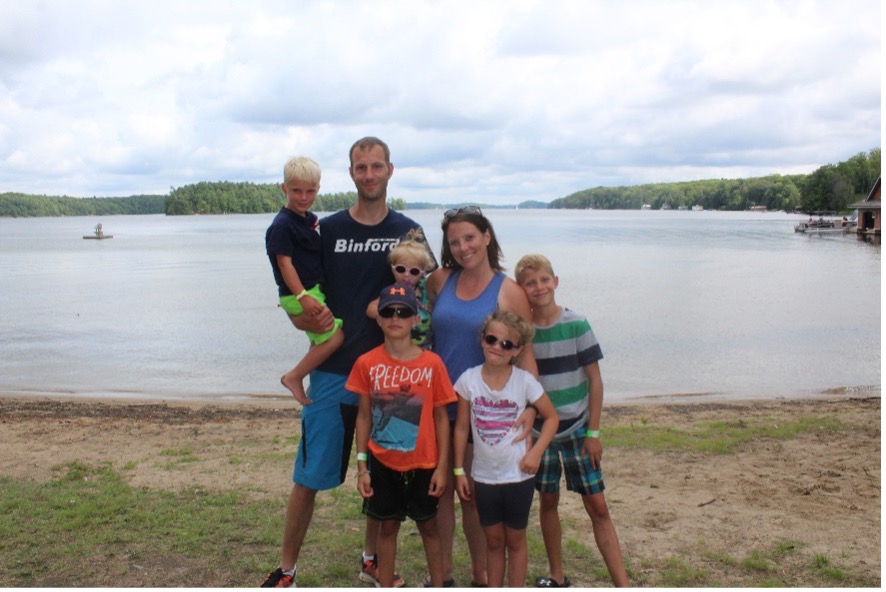 The Knip family posing for the camera on the lakeshore at CNIB Lake Joe.