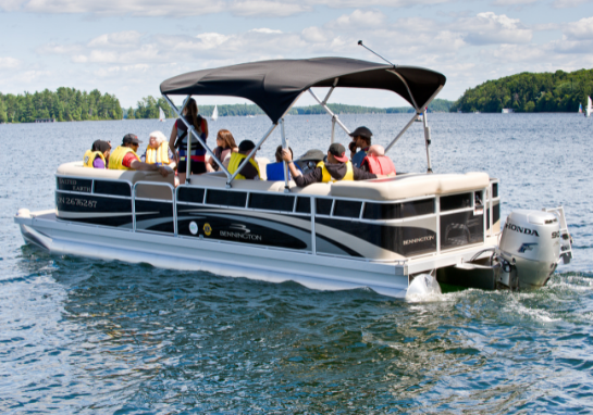 Group of adults on the pontoon boat on Lake Joseph