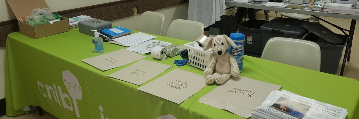 a table with pamphlets, markers, registration forms and swag