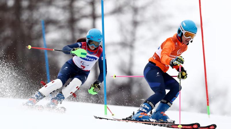 An athlete skiis with their sighted guide. Source: Olympics.com
