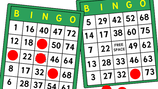 An illustration of two bingo cards and red, circular, chips marking the card. 