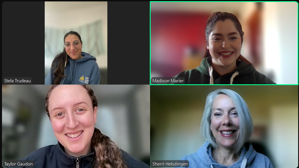 Photo of five women on a Zoom screen smiling at the camera. 