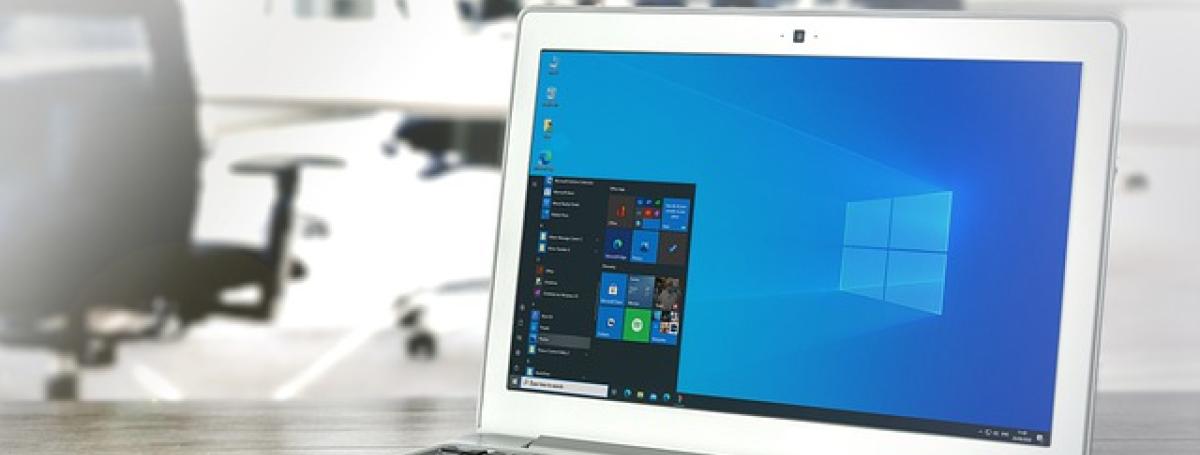 A laptop computer displays the Windows operating system. 