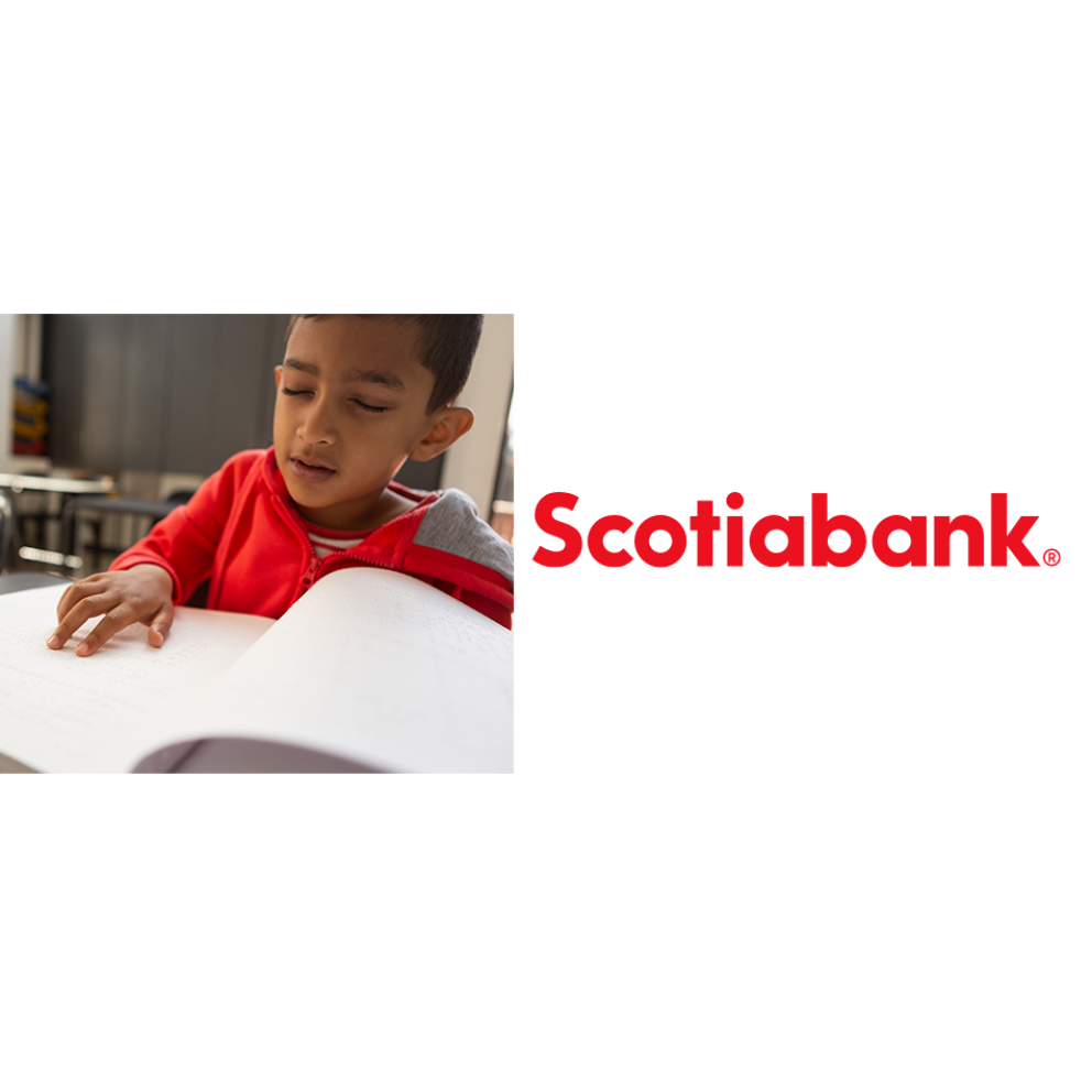 A boy in a red sweater reading braille along with the Scotiabank logo