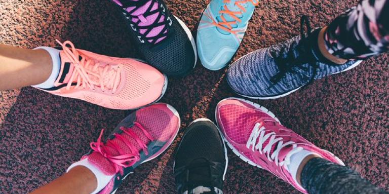 Seven different running shoes come together to form a circle. 