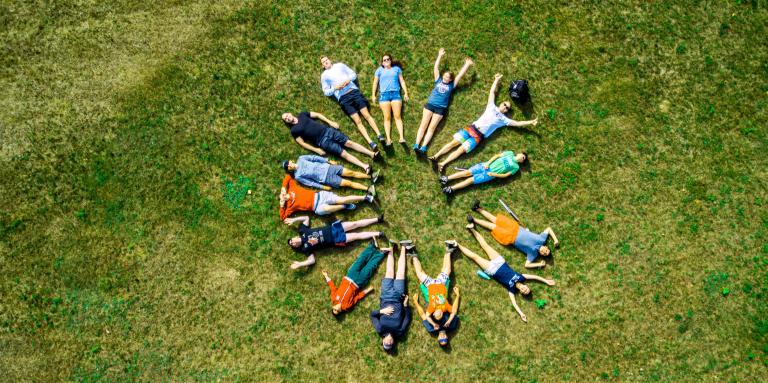 Drone shot of Camp Abilities participants lying in a circle