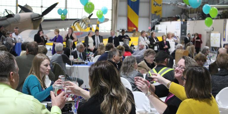 People sitting at tables in a festive setting.