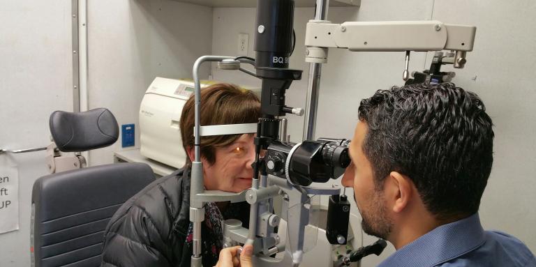 Woman getting her eyes checked by optometrist