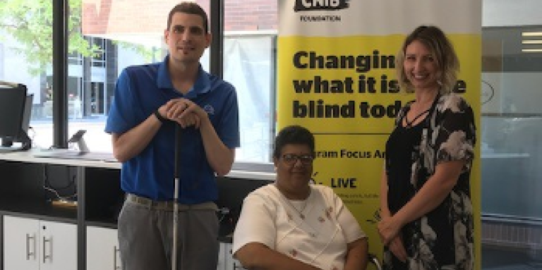 Ryan Hooey poses for a photo at the London Hub with Kristeen Elliott, a Deafblind community member and DBCS Ambassador, and Christine, an Intervenor. 
