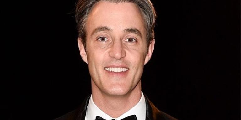 Image of a smiling Ben in a tuxedo