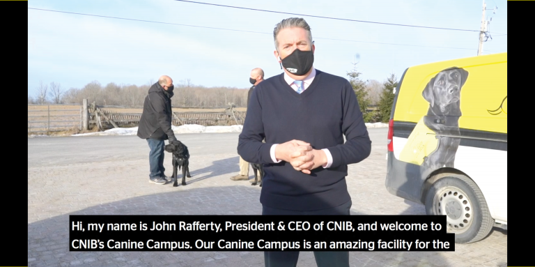 A thumbnail for a video of a virtual tour through CNIB's Canine Campus. The image shows John Rafferty greeting the viewer, and introducing the Canine Campus.
